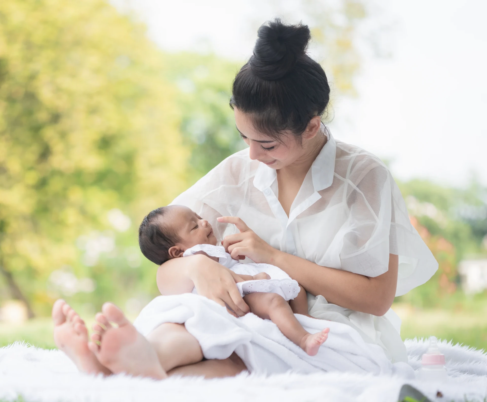 Mother gently cradling her newborn baby in a calm, natural breastfeeding moment