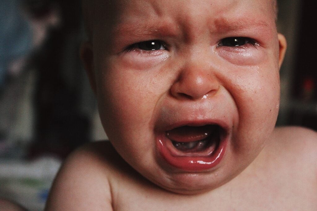 A close-up of a crying baby’s face