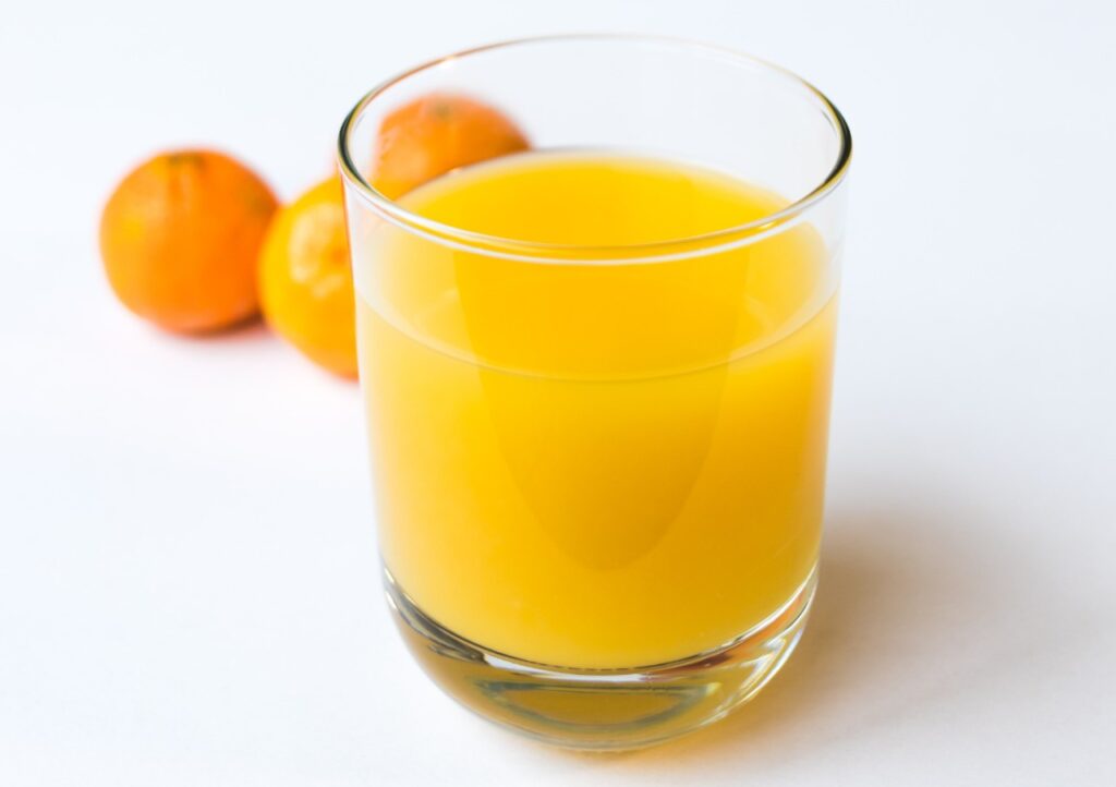 Image of a glass of orange juice, which only has 124 mg of vitamin C.